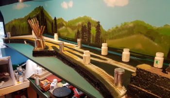 Glued all the foam in place today, so now that is settled. When dry I will turn the layout around so I can finish the back while I can reach it. Last is pictures on the wheels mounted on axles and painted. I do not have enough of them yet, but soon to be.