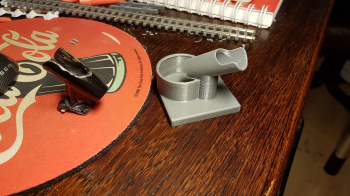 My airbrush stand which was included with the compressor had two problems. 1) It had to be glued in place. 2) I often forgot to tighten the screw before I did a re-fill, which made paint flow over my entire table.. I had to fix that and why not print a ..