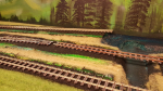 Baby steps today, but in the right direction - forward! Added a bit more grass in the background, painted all sleepers light-gray and begun to paint the rails rusty. The layout starts to blend in with the background now, which is one of the main purposes,